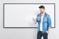 Man looking at smartphone, black whiteboard Royalty Free Stock Photo