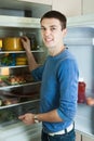 Man looking for something in pan near fridge Royalty Free Stock Photo