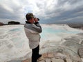 A man looking through a spotting scope from above at the panorama of Pamukkale, Turkey Royalty Free Stock Photo