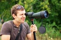 Man looking through a spotting scope Royalty Free Stock Photo