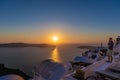 Man looking on sunsent caldera and speaking mobile phone at Santorini island, Greece