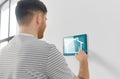Man looking at tablet computer at smart home Royalty Free Stock Photo