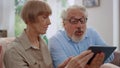 Man looking at tablet screen with woman.Grandparents using tablet for video call Royalty Free Stock Photo