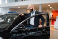 Man looking on transport interior, car dealership