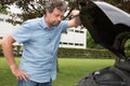 Man Looking Under The Hood Of Breakdown Car van