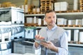 man looking up details on tablet in hardware Royalty Free Stock Photo