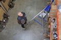 Man looking up at shelves in warehouse Royalty Free Stock Photo