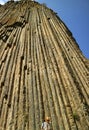 Man looking up to 50 meters high amazing basalt columns know as Symphony of Stones at Garni Gorge, Armenia