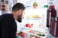 Man Looking At Vegetables In Refrigerator Royalty Free Stock Photo