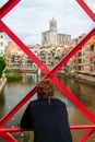 Man looking at view from Eiffel Bridge Pont de les Peixateries Velles over the Onyar River in Girona, Spain Royalty Free Stock Photo