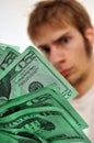 Man looking at a wad of green cash Royalty Free Stock Photo