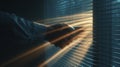 Man looking through window blinds with sunlight streaming in dramatic light stock photo image Royalty Free Stock Photo
