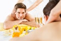 Man Looking At Woman While Receiving Shoulder Massage In Spa Royalty Free Stock Photo