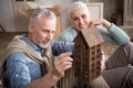 Man looking at wooden house model in hands with smiling wife Royalty Free Stock Photo