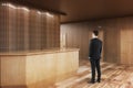 Man looking at wooden reception