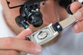 Man Looking Wrist Watch With Loupe