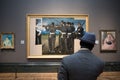 Man looking at the "The Execution of Emperor Maximilian" painting at the London National Gallery