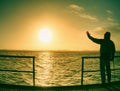 Man lookking over silent sea to horizon. Royalty Free Stock Photo