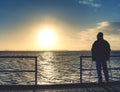 Man lookking over silent sea to horizon Royalty Free Stock Photo