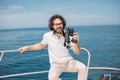 Man looks through binoculars from the boat