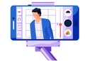 The man looks at the camera. Smartphone photo editing app. Broadcast from phone fixed to a monopod