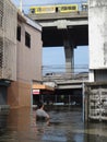 A man looks at the damage in a flooded street in Rangsit, Thailand, in October 2011. Some cars are parked safely on a bridge