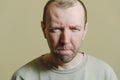 The man looks on with disapproval. Portrait of a young man making faces