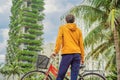 man looks at Eco architecture. Green cafe with hydroponic plants on the facade. Ecology and green living in city, urban Royalty Free Stock Photo