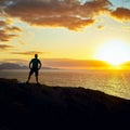 Man looks at the evening over the sea and the sunset on the Canary Islands in the evening light