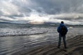 Man looks on horizon with reykjavik seascape in iceland. future goals concept. nature lovers. travelling and wanderlust