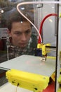 A man looks at how a 3D printer works Royalty Free Stock Photo