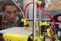 A man looks at how a 3D printer works