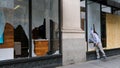 A man looks inside a vandalized store