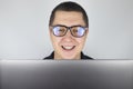 The man looks into the laptop, laughs and is surprised at what he saw there. Expression of emotions and reaction to what you see Royalty Free Stock Photo