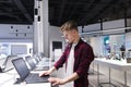 Man looks at laptops in the computer department at the technology store. Buy a laptop Royalty Free Stock Photo