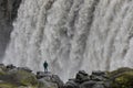 A man looks into the mighty torrents of the Dettifoss.