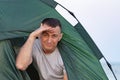 Man looks out of tent. Camping, hiking, outdoor activities