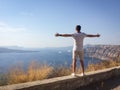 A man looks at the sea with his hands spread wide on a hot summer day Royalty Free Stock Photo