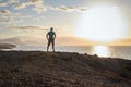 Man looks at the sea and the sunset on the west coast of Fuerteventura in the evening light Royalty Free Stock Photo