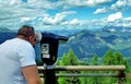 A man looks through a telescope to the mountains Royalty Free Stock Photo