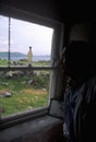 Man looks at View from inside a cottage looking out the window, Cork, Ireland