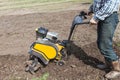 Man loosens the soil cultivator Royalty Free Stock Photo