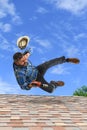 Man Loosing Balance on Top of Roof