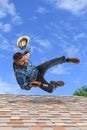 Man Loosing Balance on Top of Roof Royalty Free Stock Photo