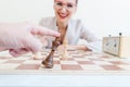 Man loosing game of chess against business woman