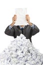 Man with lots of crumpled paper Royalty Free Stock Photo