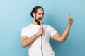 Man loudly singing song holding microphone in hand, having fun resting in karaoke singer performance Royalty Free Stock Photo