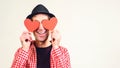 Man in love. Happy man covered his eyes by red hearts, isolated on white. Copy space. Happy Valentine day. Funny man in black hat Royalty Free Stock Photo