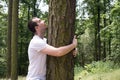 man love nature hug tree forrest save planet climate change increases levels of hormone oxytocin