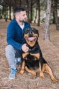 Man lovingly playing with his rottweiler dog Royalty Free Stock Photo